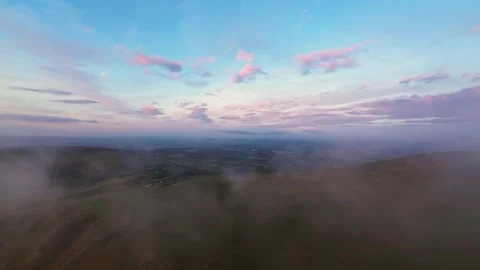 Clouds Rolling Over the Mountain at Sunrise Stock Footage 284752686