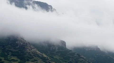 Clouds Rolling over a Mountain Time lapse Stock Footage 64666463