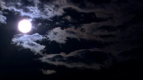 Clouds rolling over sun in dark dramatic blue sky HD Video Stock Footage 24612497