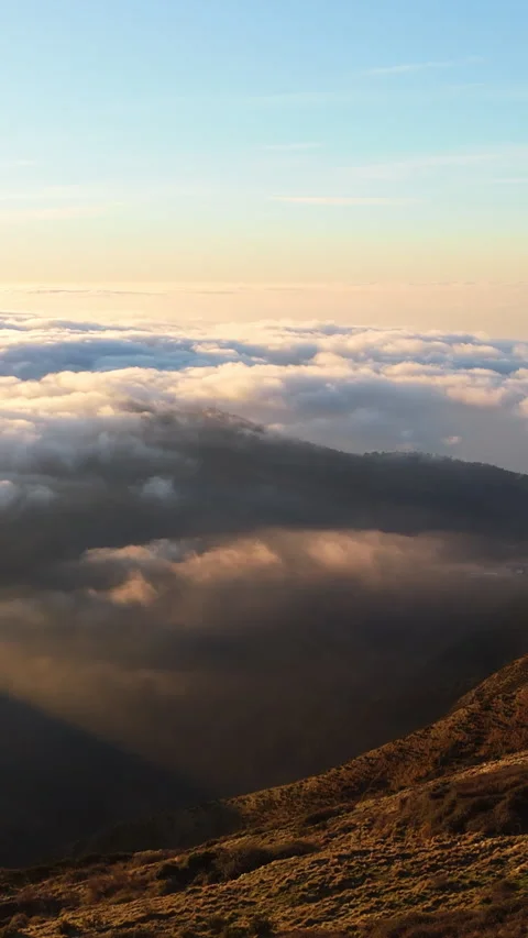 Clouds Rolling Over Sunlit Italian Alps Mountain Ridge at Sunset in Tranquil Stock Footage 334723034