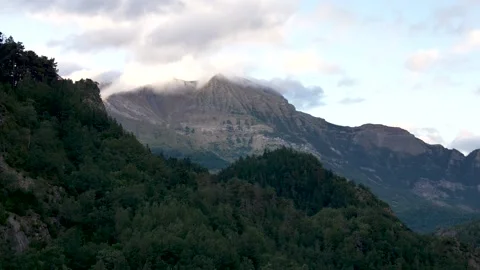 Clouds rolling over a tall mountain peak in the Pyrenees National Park. Stock Footage 290267432