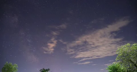 Clouds rolling in the purple night sky - time lapse Stock Footage 154385720