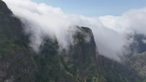 Clouds rolling off the tall cliffs at Eira do Serrado, Madeira Stock Footage 311946930