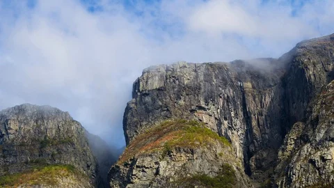 Clouds rolling through mountain range, rock formation, Stock Footage 98185521