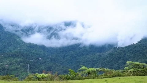Clouds run along the tops of the mountains. Video stock 124065830