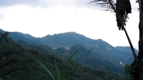 Clouds run along the tops of the mountains. Video stock 124066237