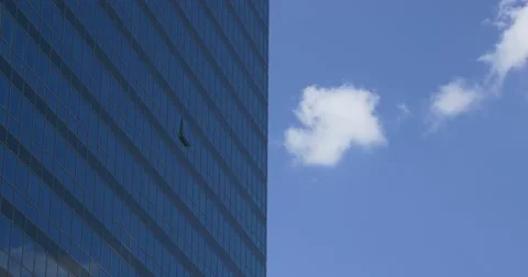 Clouds run near blue high-riser Stock Footage 67581163