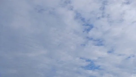 Clouds running across the blue sky. 4k timelapse video of white clouds over b Stock Footage 101535838