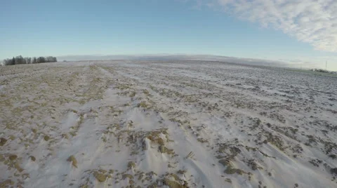 Clouds running over snowy field, time lapse 4K Stock Footage 58658190