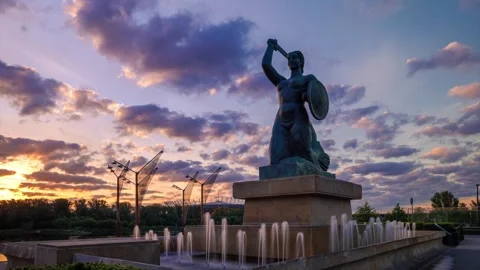 Clouds rush during sunset in a time-lapse shot over a statue of a mermaid, Stock Footage 242572969