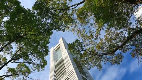 Clouds rush over the building of the Yokohama Landmark Tower. Time lapse. Stock Footage 100615050