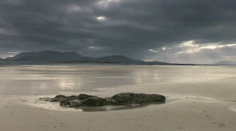 Clouds rush overhead a rocky sandy beach Stock Footage 646095