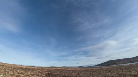 Clouds rush overhead, wide angle Scottish highland moor and lochan lake Stock Footage 313636390