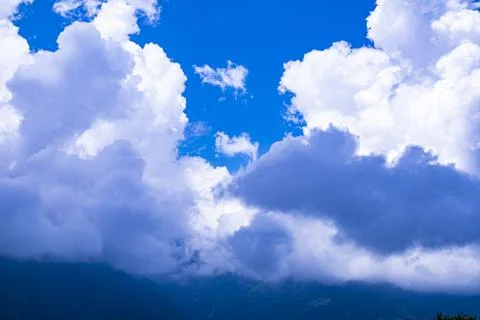 Clouds rush to the top of the mountain Stock Photos