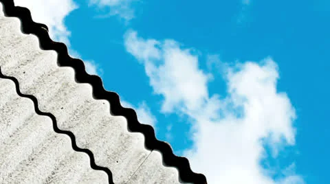 Clouds rushing across the sky over the roof line of a house Stock Footage 26319212