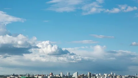 Clouds sailing above a city Stockbeeldmateriaal 76366853