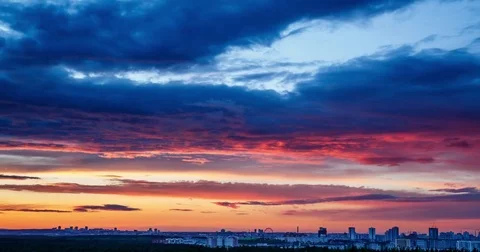 Clouds sailing above a city on sunset Video stock 76689227
