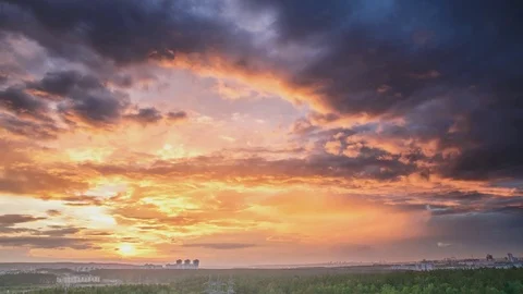 Clouds sailing above a city on sunset Stock Footage 76870220