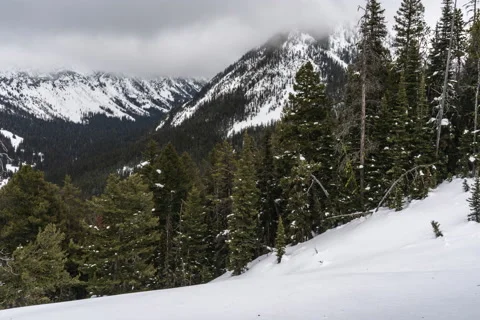 Clouds scraping mountain peak in winter Stock Footage 130880897