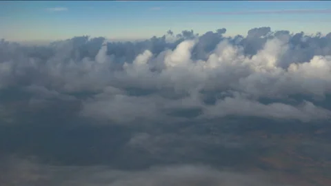 Clouds scroll across the sky over the countryside from a plane, in Brazil Stock Footage 231512399