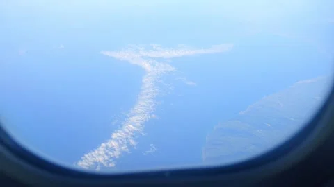 Clouds seen from an airplane window at high altitude in slow motion 60fps 스톡 동영상 290094354