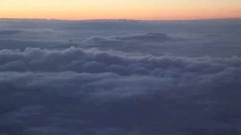 Clouds as seen from a jet a sunset. Stock Footage 128780373