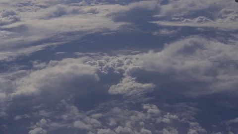 Clouds seen through the window of a commercial jet airplane at cruising altitude Stock Footage 82093528