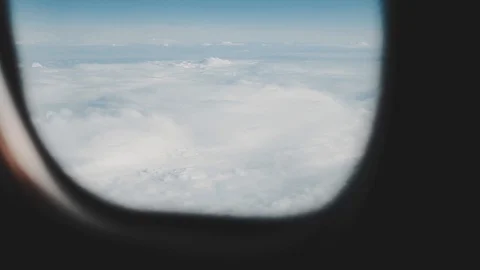 Clouds seen through the window of jet airplane. Airplane flies above the weather Stock Footage 88096858