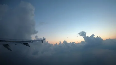 Clouds Seen Through The Window Of Jet AirplaneWing of an airplane flying above Stock Footage 103669287