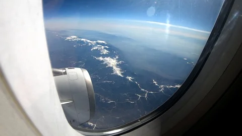 Clouds Seen Through The Window Of Jet AirplaneWing of an airplane flying above Stock Footage 103669514