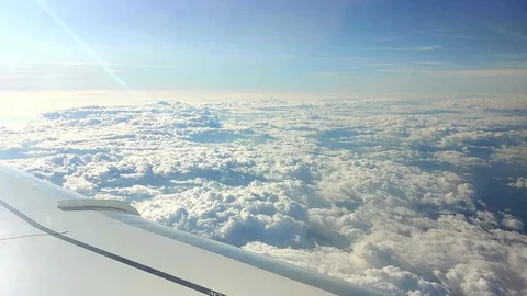 Clouds as seen from a windows of an airplane - flying above the clouds Stock Footage 128929025
