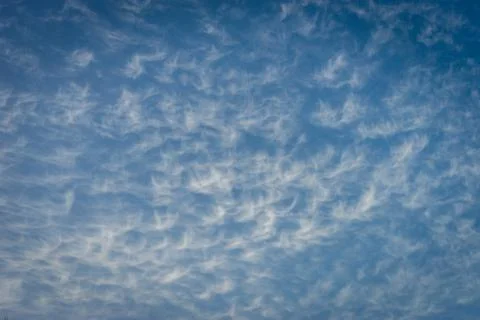 Clouds in the shape of angels float across a blue sky in Malaga, Spain, Europ Stock Photos