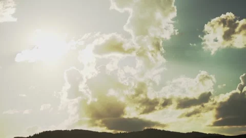 Clouds shaped like tufty pillows glide slowly across the sky. Stock Footage 280192330