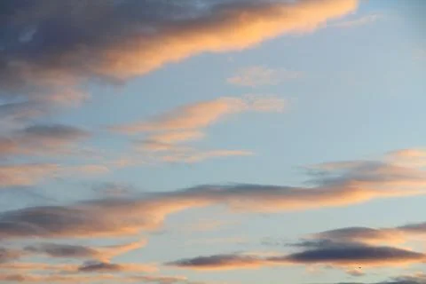 Clouds in the sky are illuminated from below by the red light of the sun. Sunset Foto stock