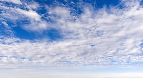 Clouds on sky background blue texture. Bright clouds soft white pattern. Da.. Stockfoto's