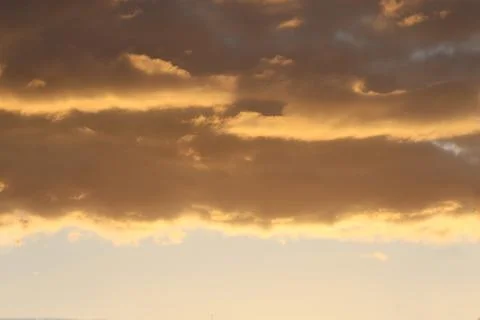 Clouds in the sky backlit by the sun. Stock Photos