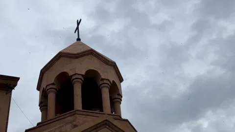Clouds in sky of birds flying over medieval church Armenian architecture Stock Footage 338348123