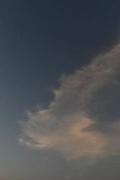 Clouds in the sky drifting away in a light breeze Stock Photos