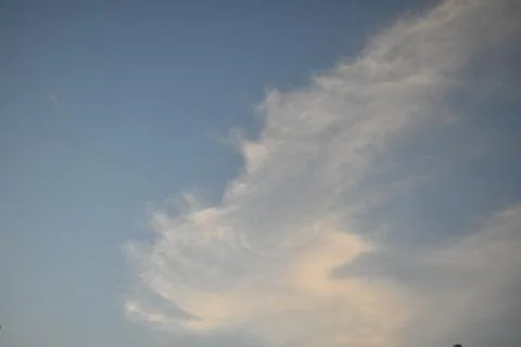 Clouds in the sky drifting away in a light breeze Stock Photos