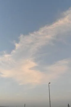 Clouds in the sky drifting away in a light breeze Stock Photos