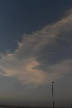 Clouds in the sky drifting away in a light breeze Stock Photos