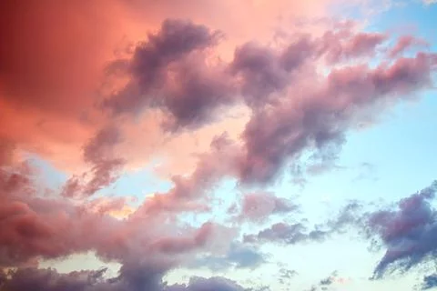 Clouds in the sky illuminated by the setting sun. Stock Photos