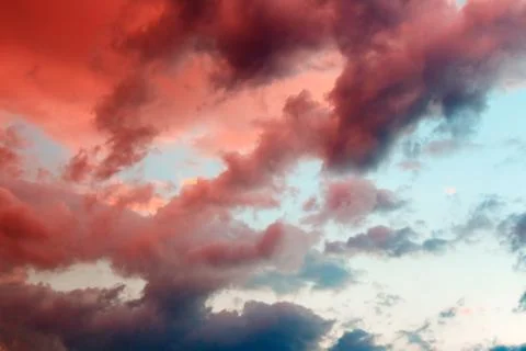 Clouds in the sky illuminated by the setting sun. Stock Photos