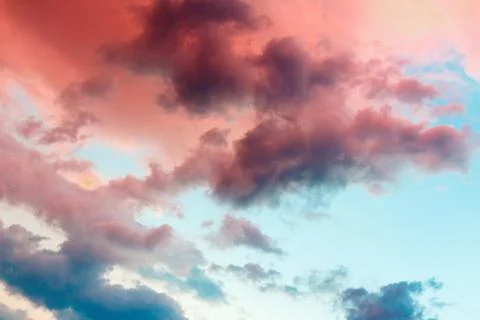 Clouds in the sky illuminated by the setting sun. Stock Photos