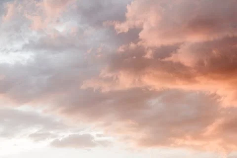 Clouds in the sky illuminated by the setting sun. Stock Photos