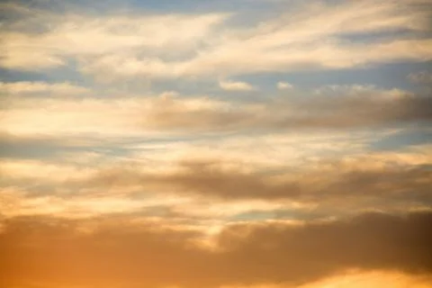 Clouds in the sky lit by the sun at sunset.	 Stock Photos