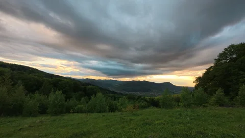 Clouds sky over forest mountains landscape at golden sunset Stock Footage 330677105