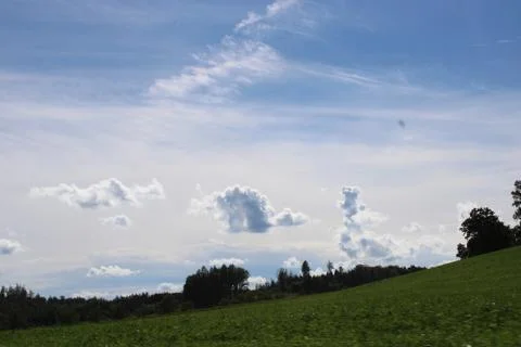 Clouds in the sky over trees Stock Photos
