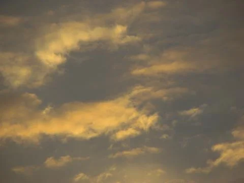 Clouds in the sky at sunset as a background. Texture. Stock Photos