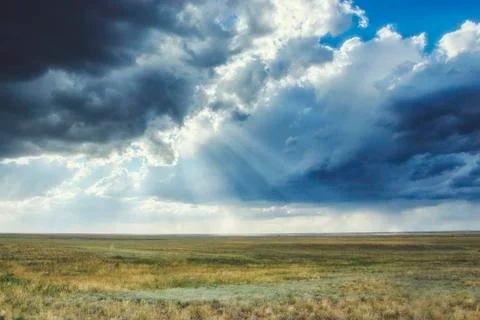 Clouds in the sky before a thunderstorm with sunbeams Stock Photos